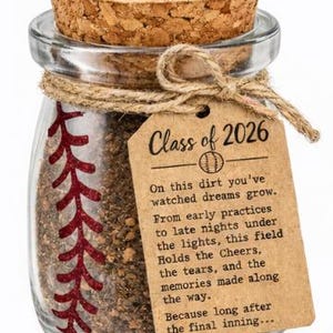 May include: A clear glass jar with a cork lid, filled with dirt and a baseball stitch design. A tag reads "Class of 2026" with a baseball graphic and a poem about memories.