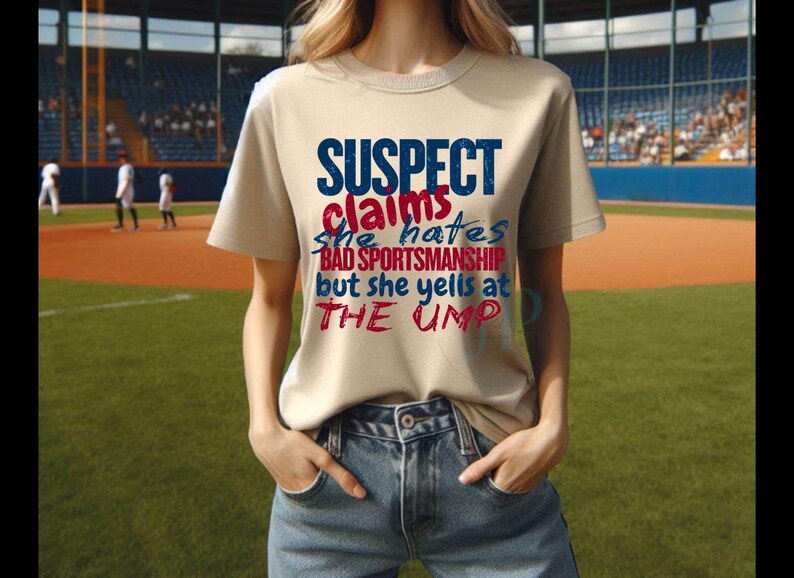 May include: A beige t-shirt with the text "SUSPECT claims she hates BAD SPORTSMANSHIP but she yells at THE UMP" in red and blue lettering.