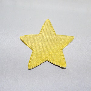 May include: A yellow star-shaped patch with a satin finish.