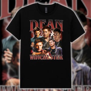 May include: Black t-shirt with a vintage-style graphic featuring several men and the text "DEAN WINCHESTER". The design incorporates a red lightning bolt effect behind the text and images.