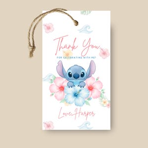 May include: A rectangular white gift tag with a jute string loop featuring a blue alien character illustration, pink and blue hibiscus flowers, and green leaves. The text reads Thank You FOR CELEBRATING WITH ME! and Love, Harper in pink script.