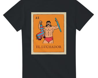 May include: Black t-shirt featuring a colorful illustration of a luchador holding a pinata and a stick. The image is a stylized representation of a Mexican lottery card, with the number "21" at the top and the words "EL LUCHADOR" at the bottom.