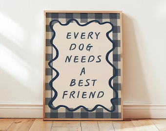 May include: A framed print with the text "EVERY DOG NEEDS A BEST FRIEND." The print has a cream-colored background with the text in dark blue. The frame is a light wood color, and the background is a blue and white checkered pattern.