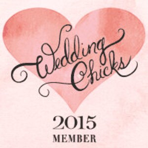 May include: A pink watercolour heart with the words "Wedding Chicks" in cursive script. Below the heart, the text "2015 MEMBER" is displayed. The background has a soft, textured appearance. The image has a vintage feel.
