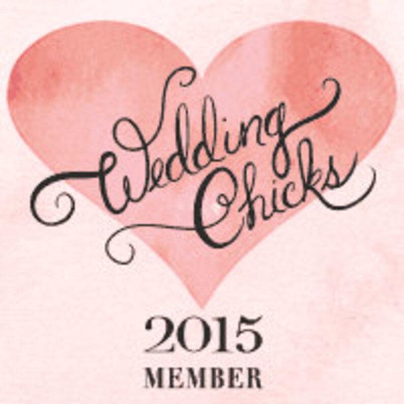 May include: A pink watercolour heart with the words "Wedding Chicks" in cursive script. Below the heart, the text "2015 MEMBER" is displayed. The background has a soft, textured appearance. The image has a vintage feel.