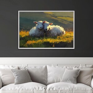 May include: A framed art print featuring two white sheep nestled together in a field of green and yellow grass. The background shows rolling hills under a warm, golden light, creating a peaceful pastoral scene.