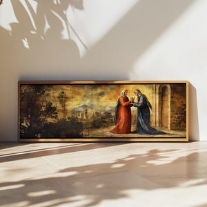 May include: A framed religious painting depicts two figures in long robes, one in red and the other in blue, with a cityscape background. The artwork is set in a wooden frame and leans against a white wall.