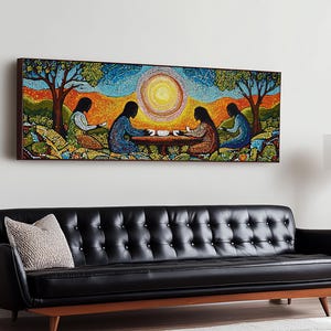 May include: A long, rectangular framed artwork depicts four figures seated around a table under a bright sun. The artwork features a mosaic-like style with vibrant colors, including blues, greens, and oranges. The painting hangs above a black leather sofa.