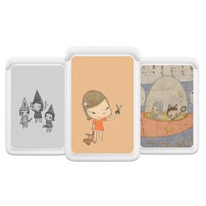May include: Three phone cases with cartoon illustrations. The left case has a gray background with three figures in witch hats. The center case has a peach background with a girl holding scissors and a stuffed animal. The right case has a blue and white illustration.