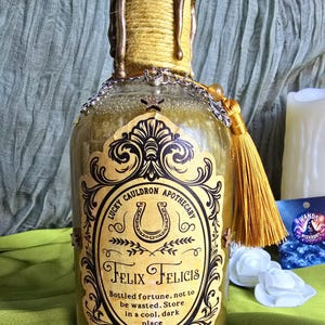 Felix Felicis decorative bottle, magical, mystical, display, luck, gold, charms, sealed.