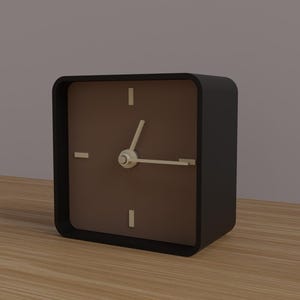 May include: A square black analog clock with a brown face. The clock has white hands and white markers at the 12, 3, 6, and 9 o'clock positions. The clock is sitting on a wooden surface.