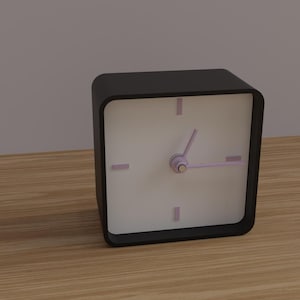 May include: A black square analog clock with a white face, featuring purple hands and hour markers. The clock sits on a wooden surface. The clock's dimensions are approximately 4 inches by 4 inches.