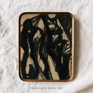 May include: Abstract black ink painting on a rectangular tray with a gold-colored frame. The artwork features bold brushstrokes and the text "FOXGLOVE WALL ART" at the bottom.