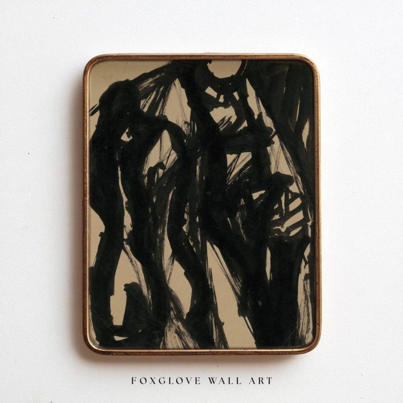 May include: Abstract black ink painting on a beige background, framed in a gold-toned rectangular frame. The artwork features bold brushstrokes and the text "FOXGLOVE WALL ART" at the bottom.