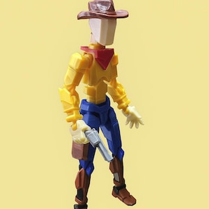 May include: A toy cowboy figure with a brown hat, yellow shirt, blue pants, and brown boots. The figure is holding a silver toy gun and has a red bandana. The figure is approximately 6 inches tall.
