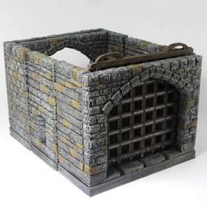May include: A miniature dungeon cell model, constructed from gray and yellow-toned stone blocks. The cell features an arched doorway with a metal gate, and a wooden beam with a handle on top. Ideal for tabletop gaming.