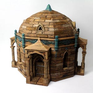 May include: A detailed, miniature model of a domed building with a stone-like texture. The structure features arched doorways, pillars, and teal accents. The roof is topped with a teal spire, and the overall color palette is earthy tones.