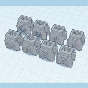 Peut inclure: Ensemble d'objets gris imprimés en 3D, chacun avec un design unique. Les motifs comprennent un smiley, un cœur, une étoile, un éclair, un "X", un point d'interrogation et le texte "USA".