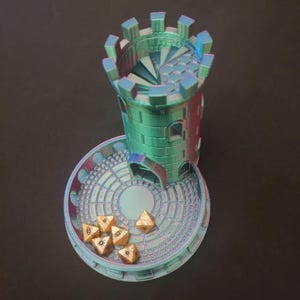May include: A teal and purple iridescent 3D printed tower with a spiral staircase inside. The tower sits on a circular base with a concentric circle pattern. Six gold dice with black eye symbols are scattered on the base.