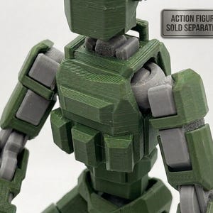 Puede incluir: Una figura de acción articulada verde y gris, con articulaciones visibles y un diseño modular. La figura tiene una estética de estilo militar, con una superficie texturizada y un torso cuadrado. El texto "ACTION FIGURE SOLD SEPARATELY" es visible.