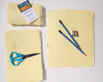 Ten little sheets of yellow handmade abaca kozo paper.