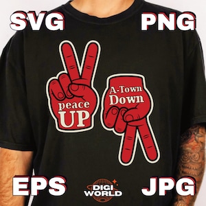 May include: Black t-shirt featuring two red hand gestures with white outlines. One hand shows a peace sign with the text "peace UP", and the other shows the same gesture upside down with the text "A-Town Down". The shirt also has the text "SVG", "PNG", "EPS", and "JPG".