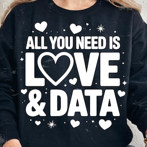May include: Black sweatshirt featuring the white text "ALL YOU NEED IS LOVE & DATA". The design includes a large heart, smaller hearts, and starbursts. A casual, comfortable top.