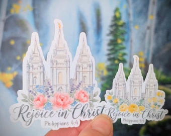 May include: Two die-cut stickers featuring a white temple illustration with spires. The larger sticker has pink flowers and the text "Rejoice in Christ Philippians 4:4". The smaller sticker has yellow flowers and the same text.
