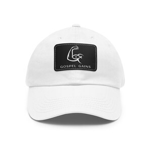 May include: White baseball cap with a black patch featuring a white silhouette of a bicep with a cross and fish inside, and the text "Gospel Gains".