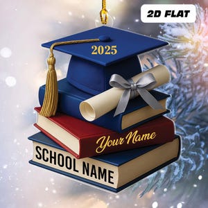 May include: A graduation-themed ornament featuring a blue mortarboard with the year 2025, a gold tassel, and a stack of books. The books are blue and red, with the words "SCHOOL NAME" and "Your Name" in gold script.