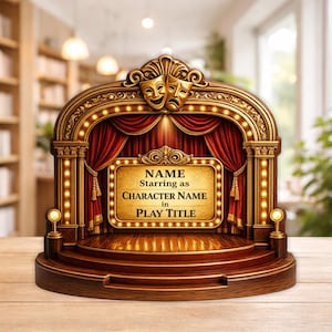 May include: A wooden theater stage-shaped plaque with a gold-colored frame, red curtains, and a sign that reads "NAME Starring as CHARACTER NAME in PLAY TITLE." The plaque features a pair of comedy and tragedy masks.