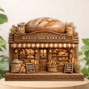 May include: A detailed, brown miniature of a bakery, with the name "Kelly Sourdough" above the awning. The shop is filled with various types of bread, with a large loaf on top. Includes the text "Handcrafted Sourdough Daily" and "Bread Made Right".