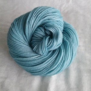 May include: A skein of light blue yarn, wound into a ball shape.