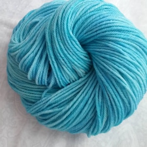 May include: A skein of light blue yarn, wound into a ball shape.