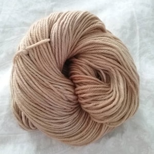 May include: A skein of light brown yarn, wound into a ball shape.