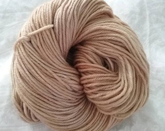 May include: A skein of light brown yarn, wound into a ball shape.