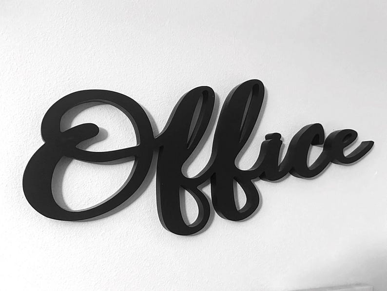 May include: A black cursive "Office" sign made of wood, mounted on a white wall. This decorative sign is designed for an office or workspace, adding a stylish element to the room.