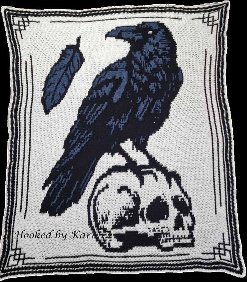 May include: A crocheted blanket featuring a raven perched on a skull, with a feather detail. The design is in shades of black and blue on a white background, framed by a black border. The text "Hooked by Kari" is visible at the bottom.
