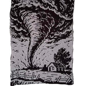 May include: A rectangular crochet blanket featuring a black and light gray graphic design of a large tornado swirling above a small house, a tree, and a wooden fence. The intricate pattern is created using contrasting yarn colors throughout.