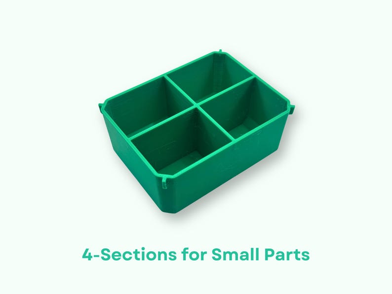 May include: A green plastic storage container with four sections. The container is designed to hold small parts.