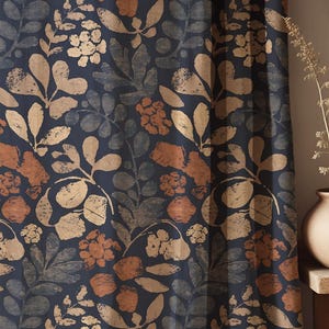 May include: Dark blue floral patterned curtain with beige, tan, and rust-colored leaves and flowers. The curtain has a repeating botanical design, creating a natural and organic aesthetic. The fabric is likely a heavy weave.