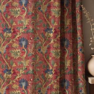 May include: Red floral patterned curtain with blue flowers, green leaves, and gold vines. The curtain has a textured appearance and is likely made of fabric. The design is repeated across the curtain's surface.