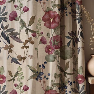 May include: Cream-coloured curtain panel with a floral watercolour design. It features burgundy flowers, green leaves, and blue berries. The botanical pattern repeats across the fabric, creating a natural, elegant aesthetic.