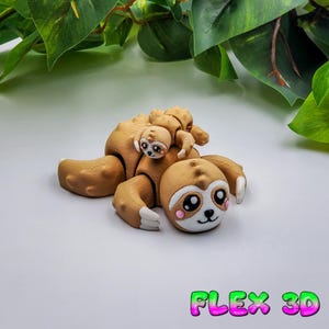May include: A brown 3D-printed sloth figurine with a baby sloth on its back. The sloth has large eyes, pink cheeks, and white accents on its paws. The text "FLEX 3D" is displayed in green and pink.