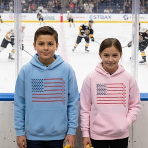 Kids Patriotic Hockey Hoodie With Hockey Sticks and Hockey Pucks in the Shape of the American Flag