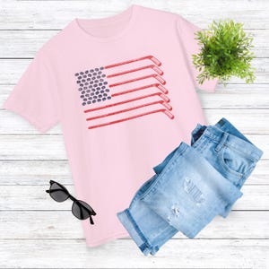 Girls Hockey Flag TShirt in Pink With Hockey Sticks and Pucks