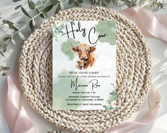 May include: A green and white baby shower invitation with a watercolor illustration of a Highland cow and calf. The text reads "Holy Cow! We're having a baby! Please join us for a baby shower in honor of Marissa Ross. Sunday, May 18 | 1 PM. Anywhere Community Building, 123 Shower St | Anywhere, IA 55555. Registered at Target and Amazon."