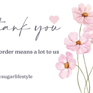 May include: A thank you card with a watercolour design. The card features the words "thank you" in cursive, along with the message "Your order means a lot to us." Pink flowers and a pink heart accent the design.