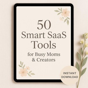 May include: A digital tablet displays the text "50 Smart SaaS Tools for Busy Moms & Creators." The image features floral accents and a circle with "Instant Download." The overall theme is productivity and digital resources.