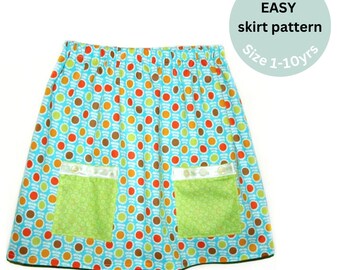 May include: A turquoise blue skirt with a colorful polka dot pattern and two green pockets. The skirt has a white elastic waistband and is labeled "Super Easy skirt pattern Size 1-10yrs".
